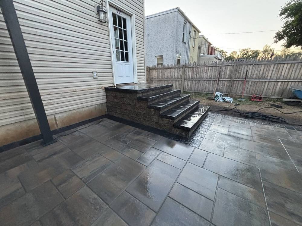 New block steps and paver patio at a back door