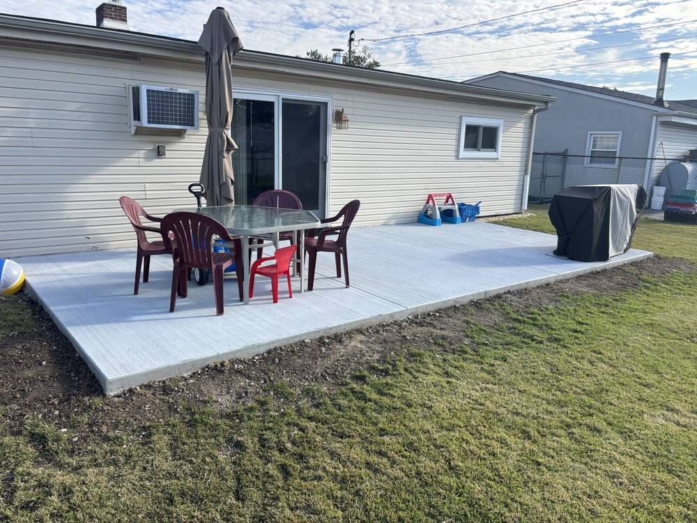 Larger new broom-finish concrete patio after