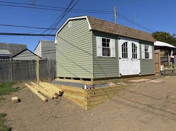 Shed on a stone pad with a timber retaining wall